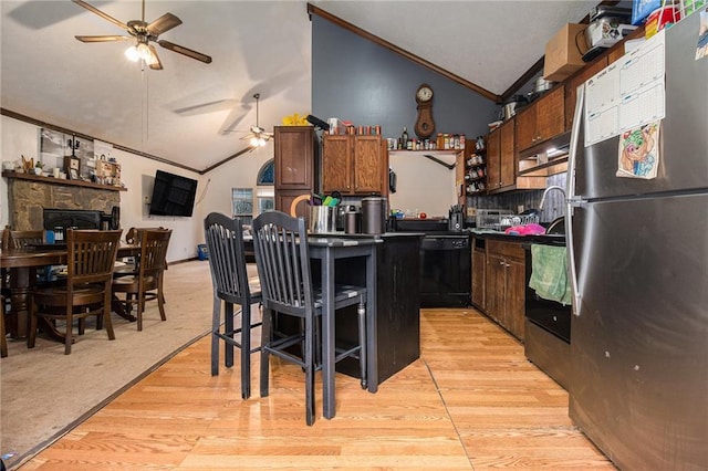 1275 Poole Bridge Rd, Hiram, GA 30141 - kitchen with freestanding refrigerator, a ceiling fan, vaulted ceiling, black dishwasher, and crown molding