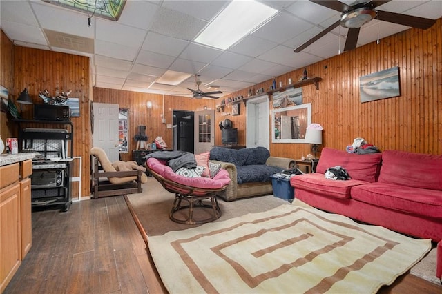 1275 Poole Bridge Rd, Hiram, GA 30141 - living room featuring ceiling fan, dark wood-style flooring, wood walls, and a paneled ceiling