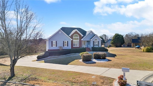 view of front of house with a front lawn and concrete driveway