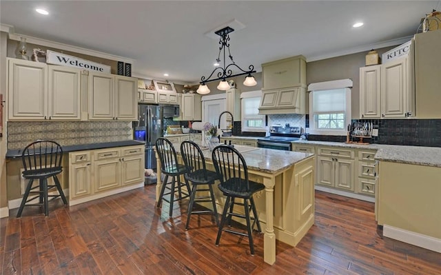 1330 Mccannon Morris Rd, Hull, GA 30646 - kitchen with stainless steel electric range, fridge with ice dispenser, decorative backsplash, a breakfast bar, and crown molding