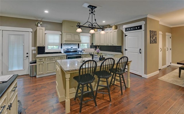 1330 Mccannon Morris Rd, Hull, GA 30646 - kitchen featuring electric range, a kitchen bar, tasteful backsplash, a kitchen island, and ornamental molding