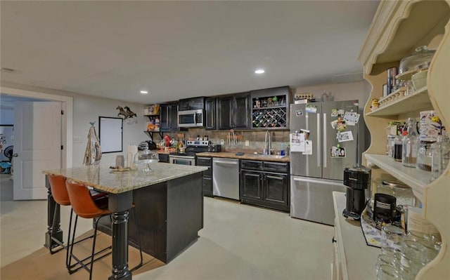 1330 Mccannon Morris Rd, Hull, GA 30646 - kitchen featuring open shelves, stainless steel appliances, a breakfast bar, a center island, and dark cabinets