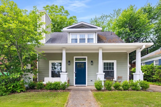 212 Haralson Ave NE, Atlanta, GA 30307 - bungalow-style house with a chimney, a front lawn, a porch, and roof with shingles