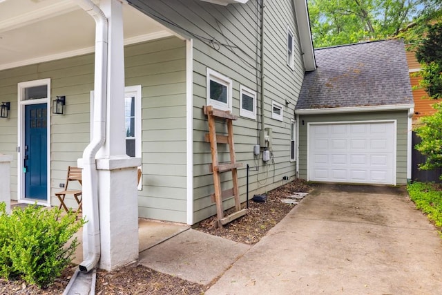 212 Haralson Ave NE, Atlanta, GA 30307 - property entrance with roof with shingles, an attached garage, and concrete driveway