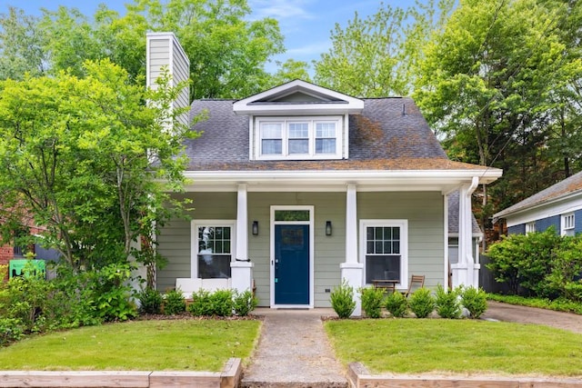 212 Haralson Ave NE, Atlanta, GA 30307 - bungalow-style home with a front lawn, a chimney, and covered porch