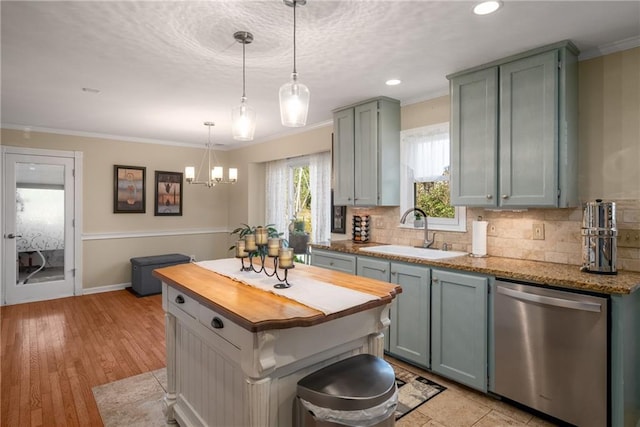 kitchen with ornamental molding, decorative backsplash, butcher block countertops, a sink, and dishwasher