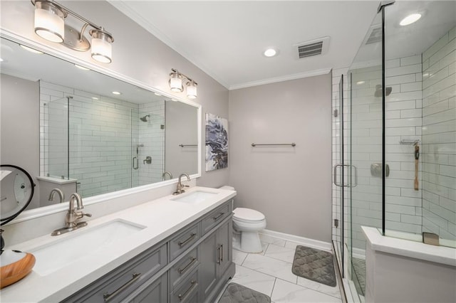 full bathroom featuring a stall shower, crown molding, baseboards, and a sink