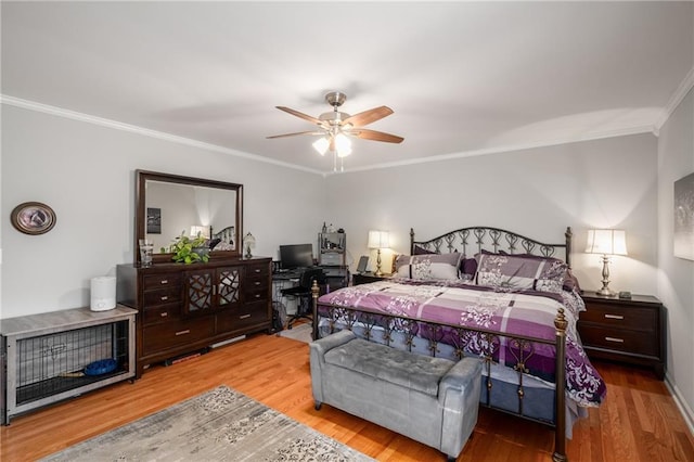 bedroom featuring a ceiling fan, crown molding, and wood finished floors