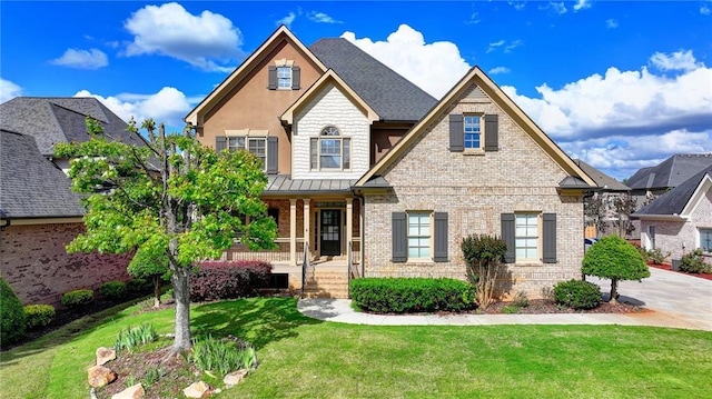 1054 Morgan Garner Dr SW, Lilburn, GA 30047 - craftsman house featuring brick siding, covered porch, a front lawn, and a standing seam roof