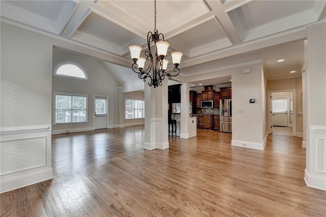 1054 Morgan Garner Dr SW, Lilburn, GA 30047 - unfurnished living room featuring light wood finished floors, coffered ceiling, a chandelier, crown molding, and beamed ceiling