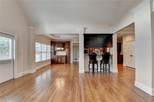 1054 Morgan Garner Dr SW, Lilburn, GA 30047 - kitchen with a kitchen bar, healthy amount of natural light, light wood finished floors, and oven