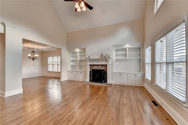 1054 Morgan Garner Dr SW, Lilburn, GA 30047 - unfurnished living room with ceiling fan, high vaulted ceiling, a chandelier, light wood-style floors, and a fireplace