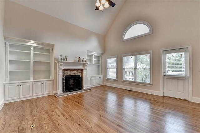1054 Morgan Garner Dr SW, Lilburn, GA 30047 - unfurnished living room with high vaulted ceiling, a ceiling fan, light wood finished floors, and a fireplace