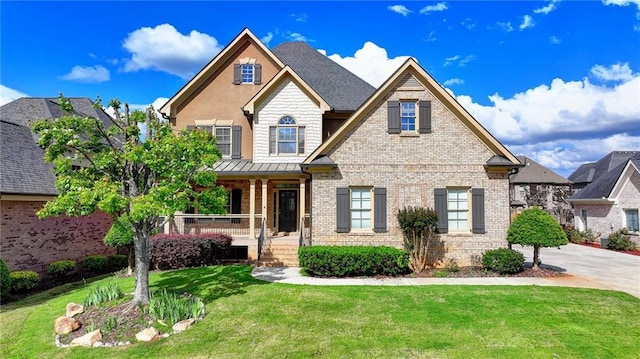 1054 Morgan Garner Dr SW, Lilburn, GA 30047 - craftsman-style house featuring brick siding, covered porch, a front yard, and a standing seam roof