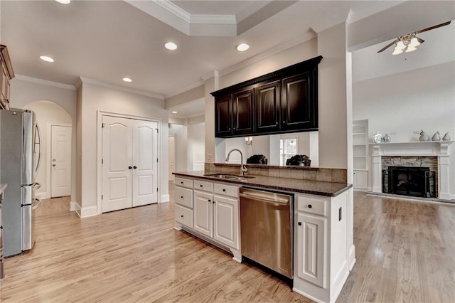 1054 Morgan Garner Dr SW, Lilburn, GA 30047 - kitchen featuring stainless steel appliances, a sink, arched walkways, light wood-style flooring, and recessed lighting
