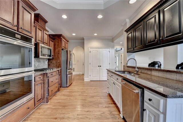 1054 Morgan Garner Dr SW, Lilburn, GA 30047 - kitchen with stainless steel appliances, a sink, crown molding, arched walkways, and recessed lighting