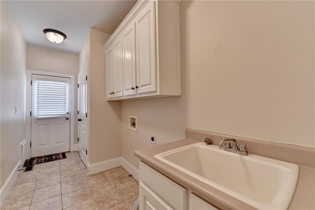 1054 Morgan Garner Dr SW, Lilburn, GA 30047 - laundry area with electric dryer hookup, washer hookup, cabinet space, baseboards, and light tile patterned floors