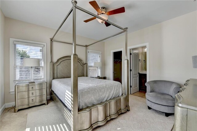 1054 Morgan Garner Dr SW, Lilburn, GA 30047 - bedroom with carpet flooring, a spacious closet, ensuite bathroom, ceiling fan, and baseboards