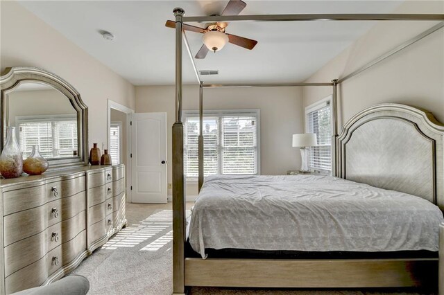 1054 Morgan Garner Dr SW, Lilburn, GA 30047 - bedroom with light carpet, multiple windows, and a ceiling fan