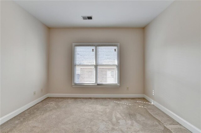 1054 Morgan Garner Dr SW, Lilburn, GA 30047 - spare room featuring carpet flooring and baseboards
