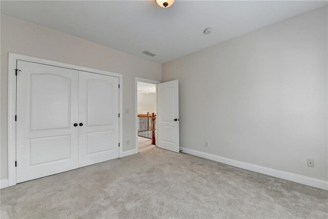 1054 Morgan Garner Dr SW, Lilburn, GA 30047 - unfurnished bedroom with carpet, baseboards, and a closet