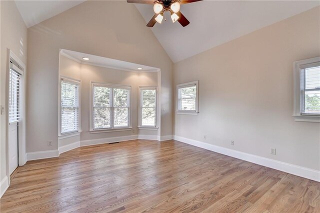 1054 Morgan Garner Dr SW, Lilburn, GA 30047 - unfurnished room featuring a ceiling fan, high vaulted ceiling, light wood-style floors, and baseboards