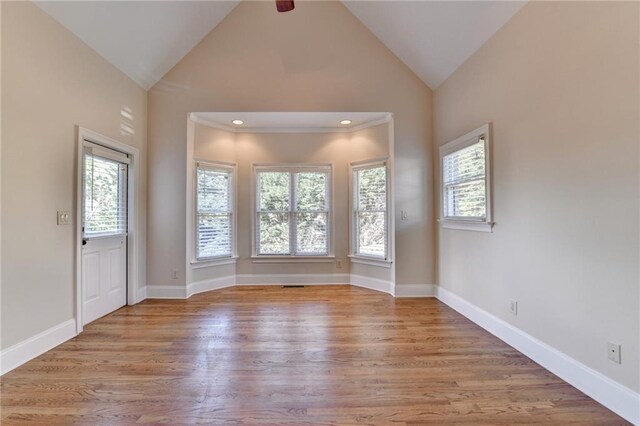 1054 Morgan Garner Dr SW, Lilburn, GA 30047 - unfurnished room with lofted ceiling, healthy amount of natural light, wood finished floors, and baseboards