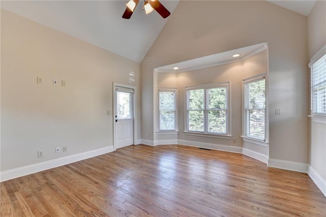 1054 Morgan Garner Dr SW, Lilburn, GA 30047 - empty room with a ceiling fan, wood finished floors, baseboards, and high vaulted ceiling