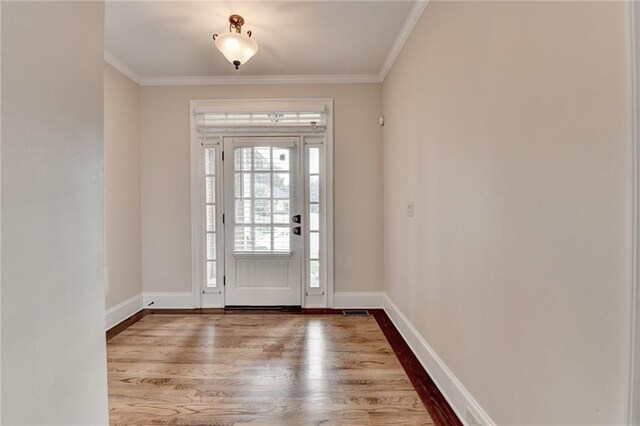 1054 Morgan Garner Dr SW, Lilburn, GA 30047 - foyer entrance with wood finished floors, ornamental molding, and baseboards