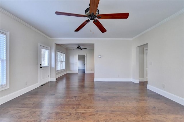 1054 Morgan Garner Dr SW, Lilburn, GA 30047 - spare room featuring crown molding, ceiling fan, wood finished floors, and baseboards