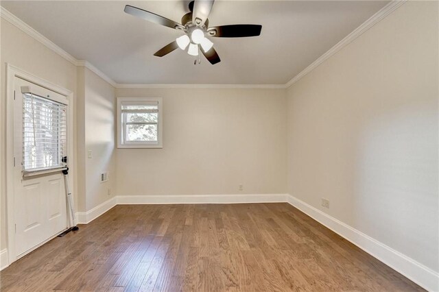 1054 Morgan Garner Dr SW, Lilburn, GA 30047 - unfurnished room with wood finished floors, crown molding, a ceiling fan, and baseboards