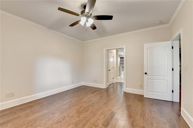 1054 Morgan Garner Dr SW, Lilburn, GA 30047 - spare room featuring ornamental molding, ceiling fan, wood finished floors, and baseboards