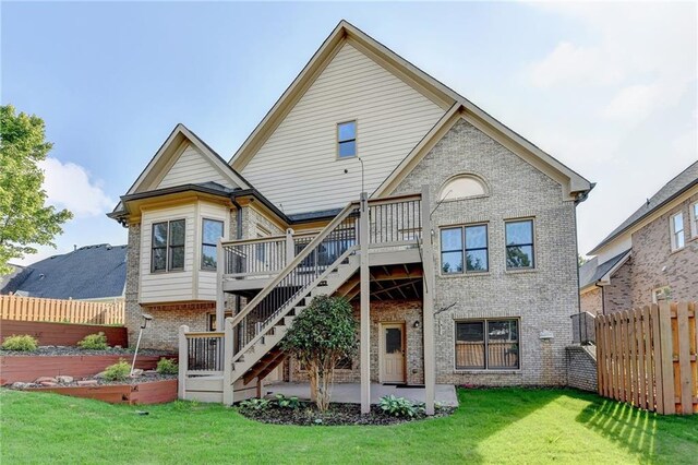 1054 Morgan Garner Dr SW, Lilburn, GA 30047 - rear view of house featuring brick siding, a wooden deck, a patio area, and stairs
