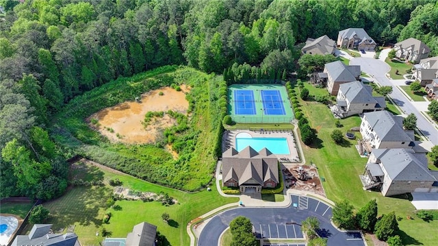 1054 Morgan Garner Dr SW, Lilburn, GA 30047 - aerial view of property's location with a pool area, a heavily wooded area, and nearby suburban area