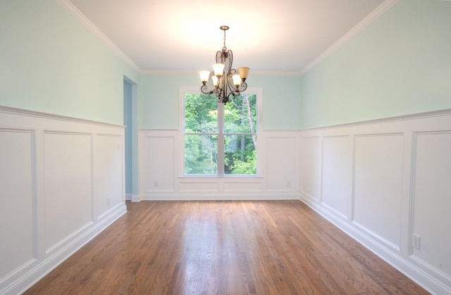 5746 Nix Bridge Rd, Gainesville, GA 30506 - unfurnished dining area with a decorative wall, a chandelier, wood finished floors, wainscoting, and crown molding