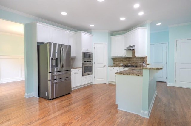 5746 Nix Bridge Rd, Gainesville, GA 30506 - kitchen featuring stainless steel appliances, a peninsula, under cabinet range hood, dark stone counters, and tasteful backsplash