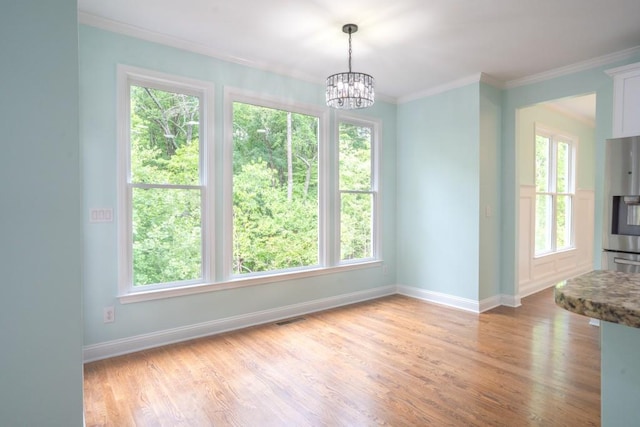 5746 Nix Bridge Rd, Gainesville, GA 30506 - unfurnished dining area featuring baseboards, ornamental molding, plenty of natural light, and light wood-type flooring