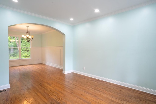 5746 Nix Bridge Rd, Gainesville, GA 30506 - empty room with arched walkways, a chandelier, wood finished floors, crown molding, and recessed lighting