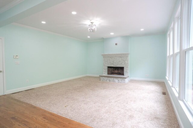 5746 Nix Bridge Rd, Gainesville, GA 30506 - unfurnished living room featuring plenty of natural light, a stone fireplace, recessed lighting, ornamental molding, and baseboards
