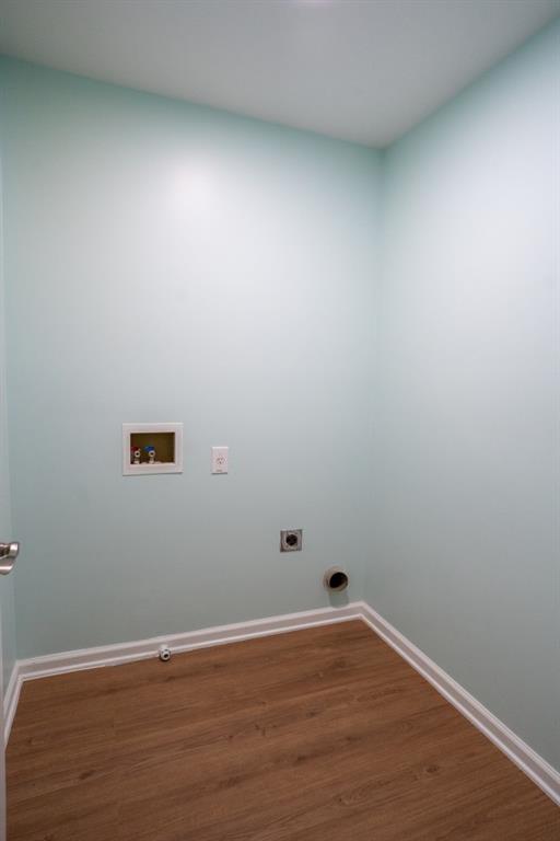5746 Nix Bridge Rd, Gainesville, GA 30506 - laundry room with hookup for a washing machine, electric dryer hookup, wood finished floors, and baseboards