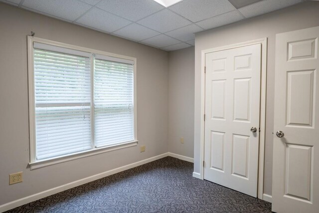 5746 Nix Bridge Rd, Gainesville, GA 30506 - unfurnished bedroom featuring dark colored carpet, baseboards, and a drop ceiling