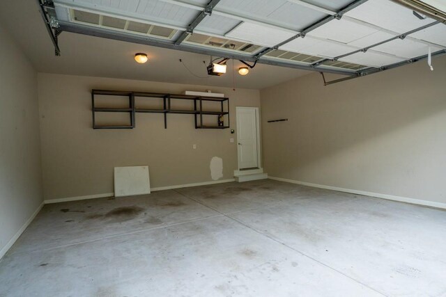 5746 Nix Bridge Rd, Gainesville, GA 30506 - garage featuring a garage door opener and baseboards