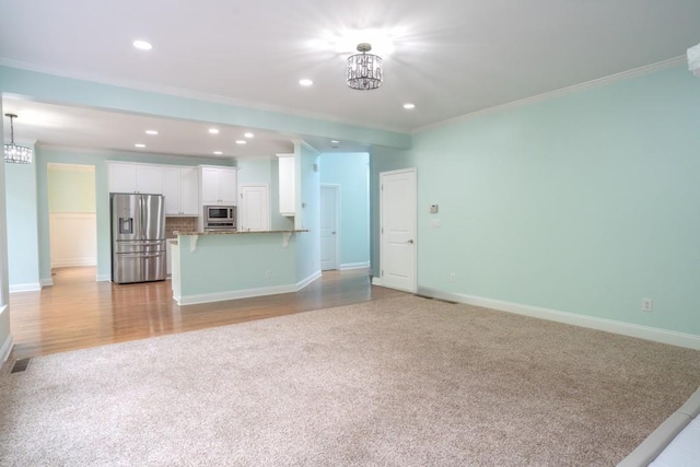 5746 Nix Bridge Rd, Gainesville, GA 30506 - unfurnished living room with light colored carpet, a chandelier, ornamental molding, recessed lighting, and baseboards