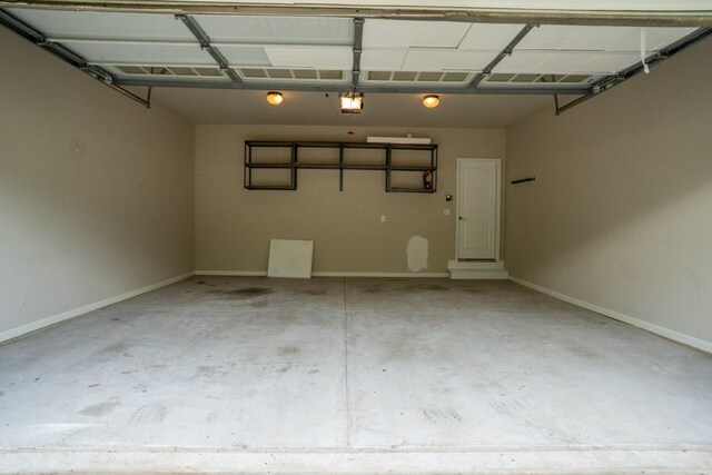 5746 Nix Bridge Rd, Gainesville, GA 30506 - garage featuring a garage door opener and baseboards