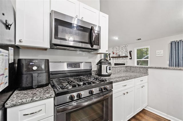 10650 Colony Glen Dr, Johns Creek, GA 30022 - kitchen with stainless steel appliances, white cabinets, and light stone counters