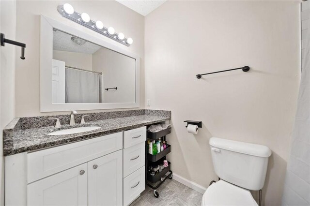 10650 Colony Glen Dr, Johns Creek, GA 30022 - bathroom featuring toilet, baseboards, and vanity