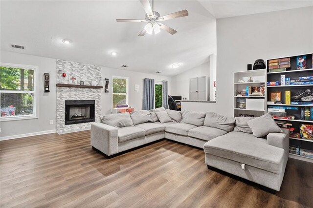 10650 Colony Glen Dr, Johns Creek, GA 30022 - living room featuring wood finished floors, vaulted ceiling, a stone fireplace, a ceiling fan, and recessed lighting