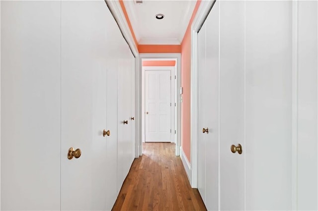 hall featuring ornamental molding and wood finished floors