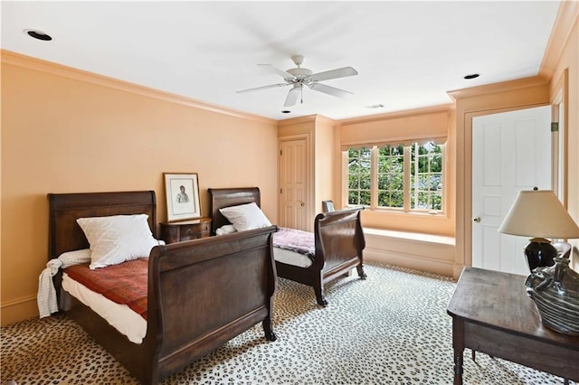 bedroom featuring ceiling fan, ornamental molding, visible vents, and light carpet