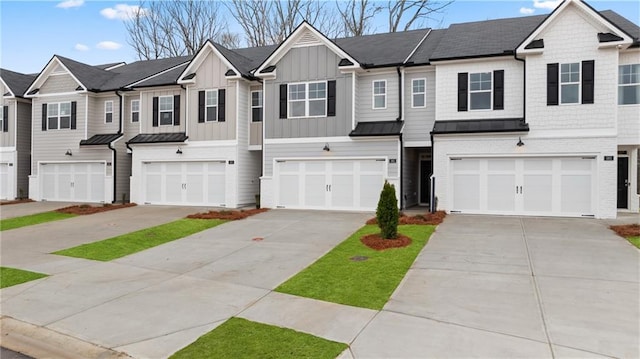 314 Sound Cir, Stockbridge, GA 30281 - townhome / multi-family property featuring a standing seam roof, an attached garage, and driveway